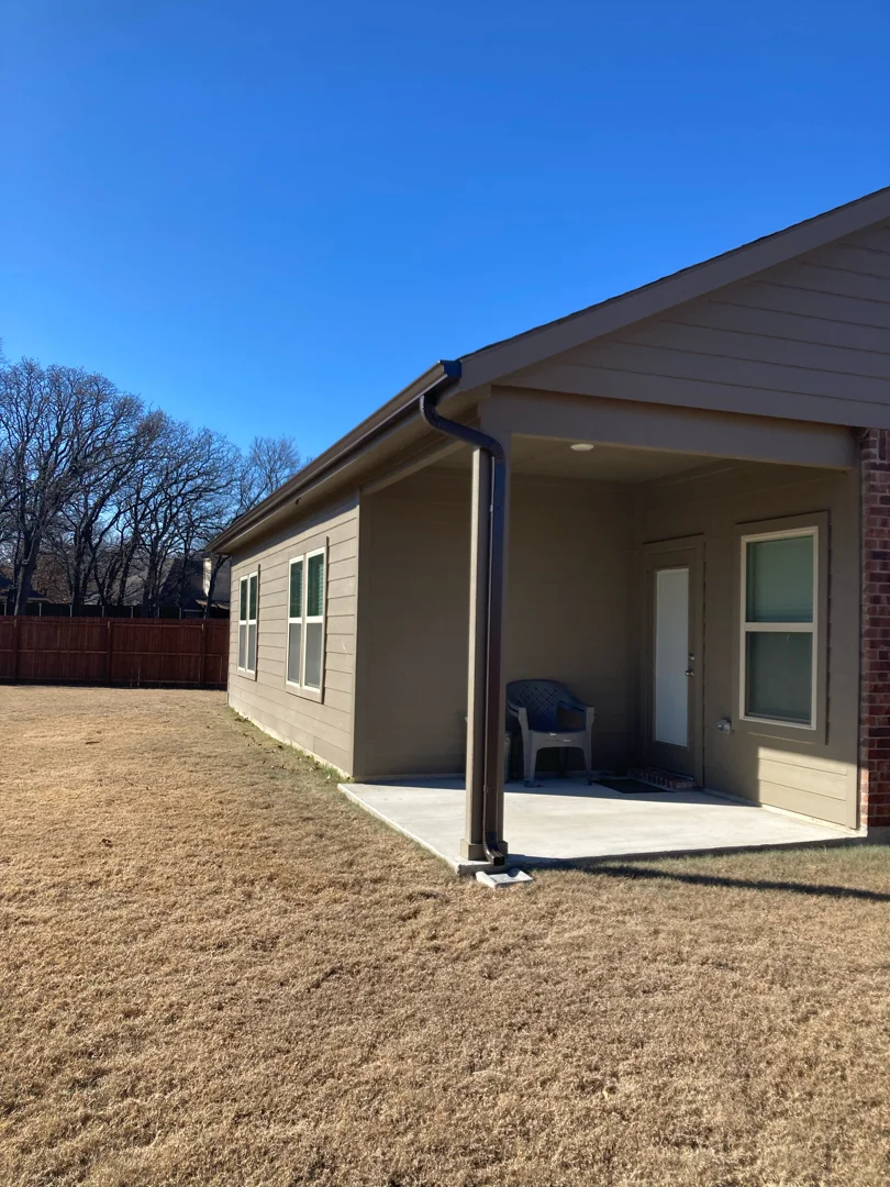 Bronze gutters and downspout on a Carrollton patio post