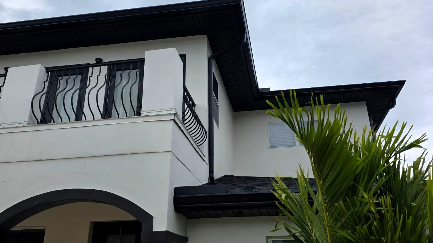 Corner downspout and drainage detail on a Dallas–Fort Worth gutter installation