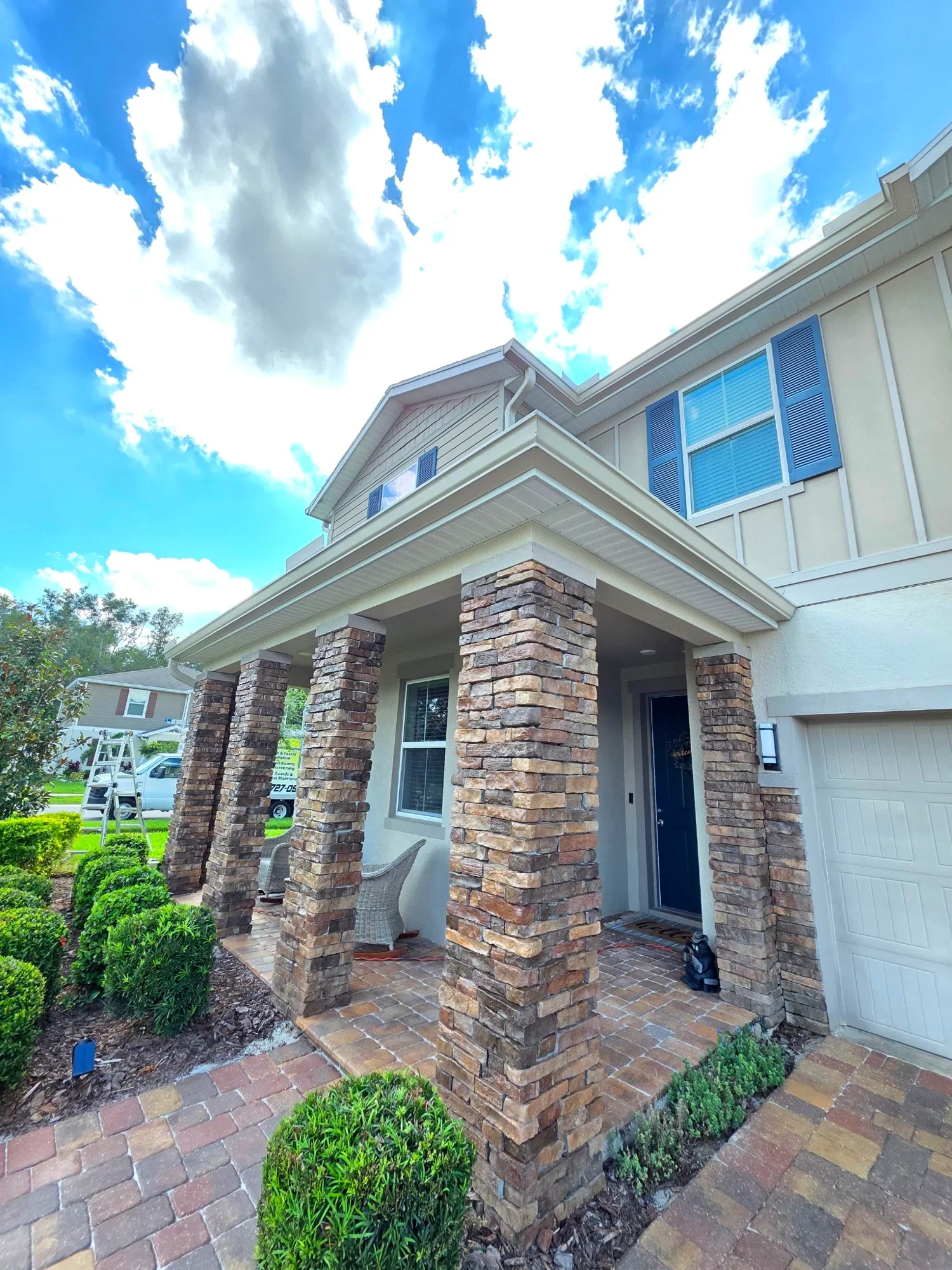 Front porch seamless gutter installation on a Dallas home