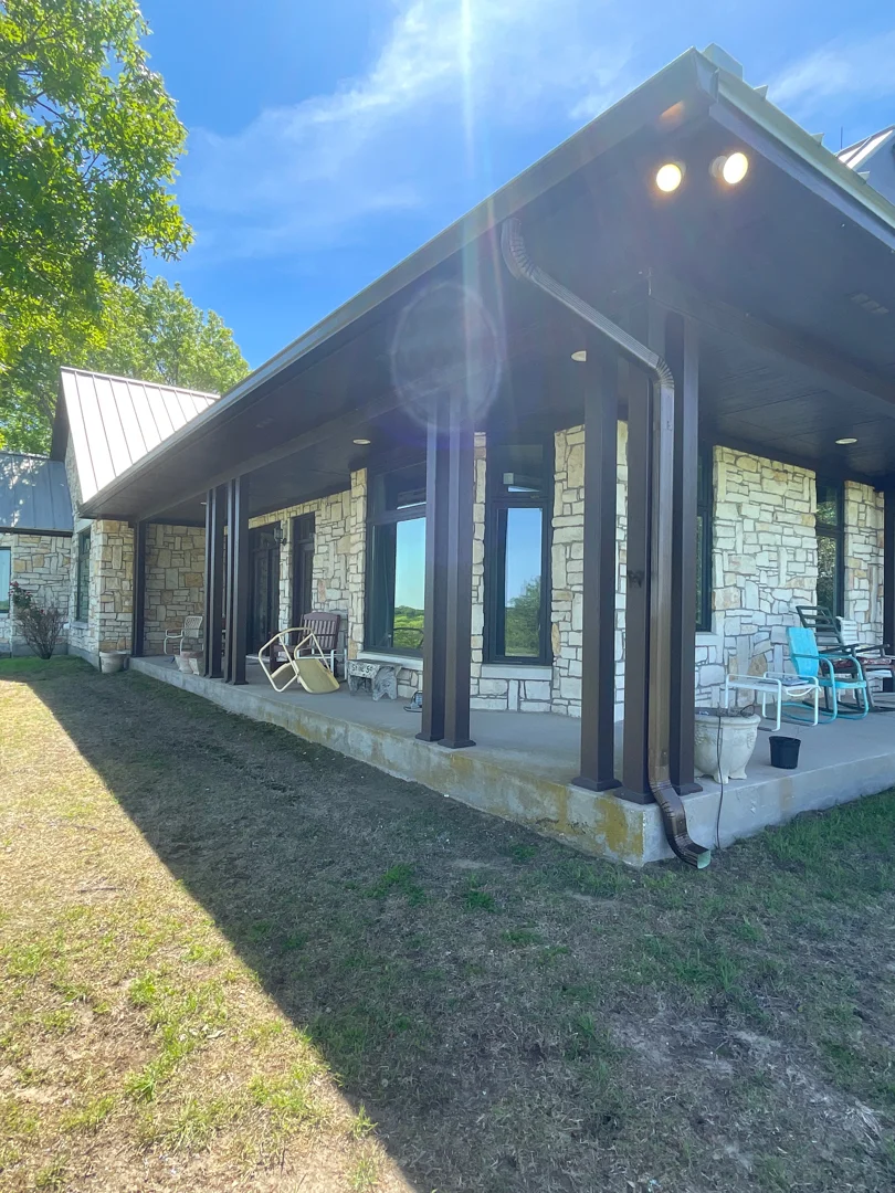Bronze gutters on a stone porch outdoor living area