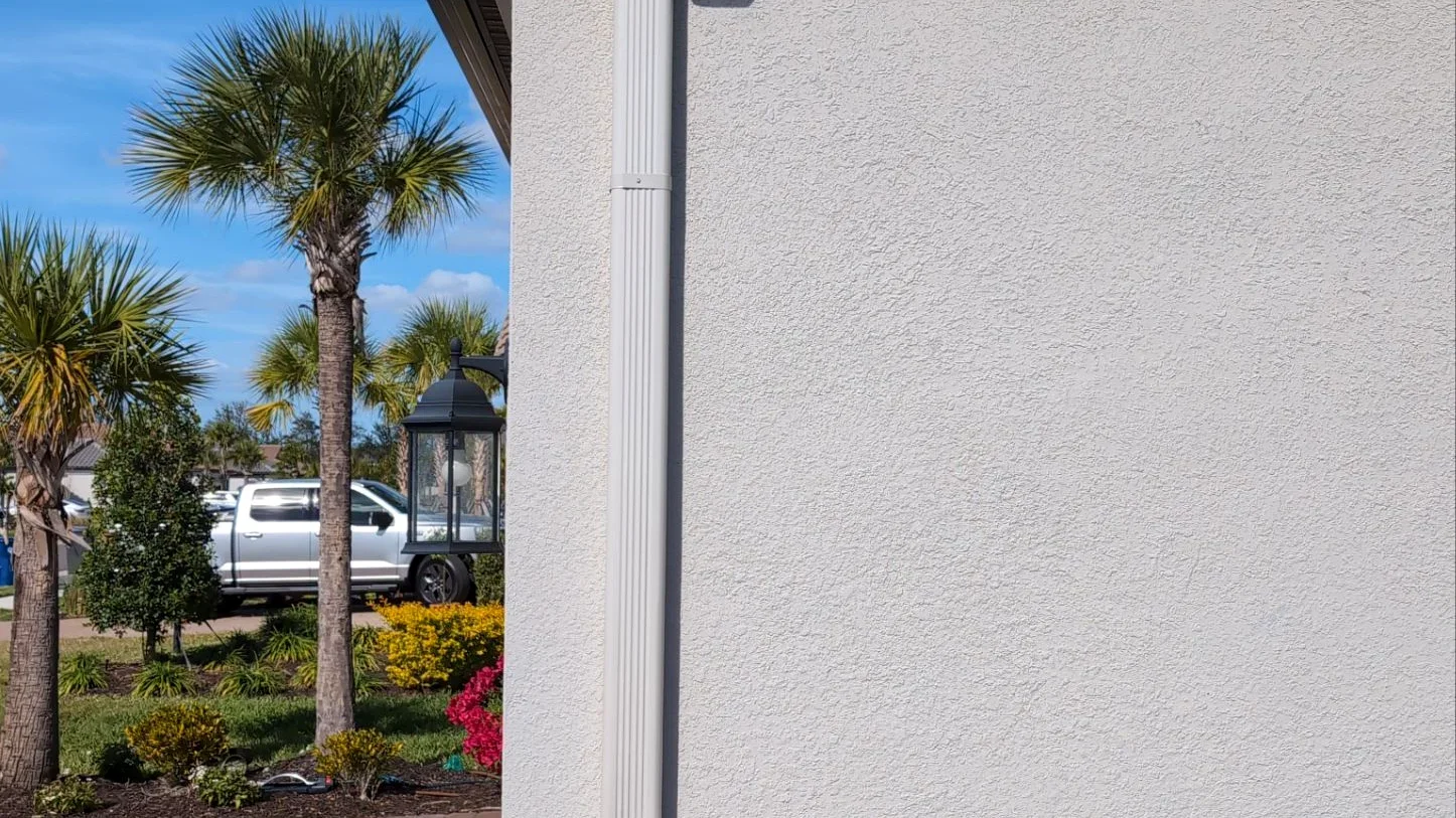 Close-up of a gutter and downspout detail in Denton