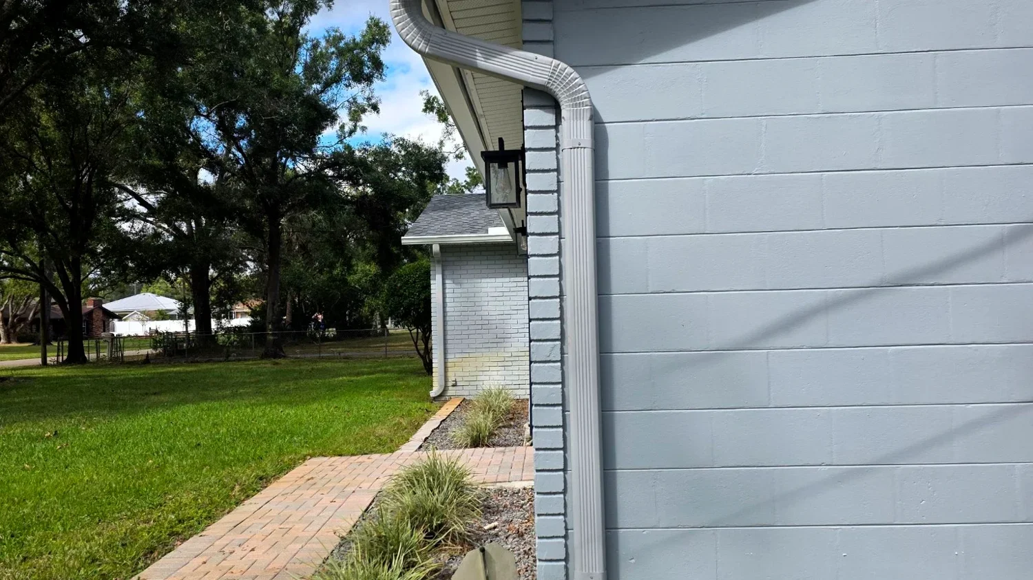 White gutter and downspout detail on a Flower Mound home