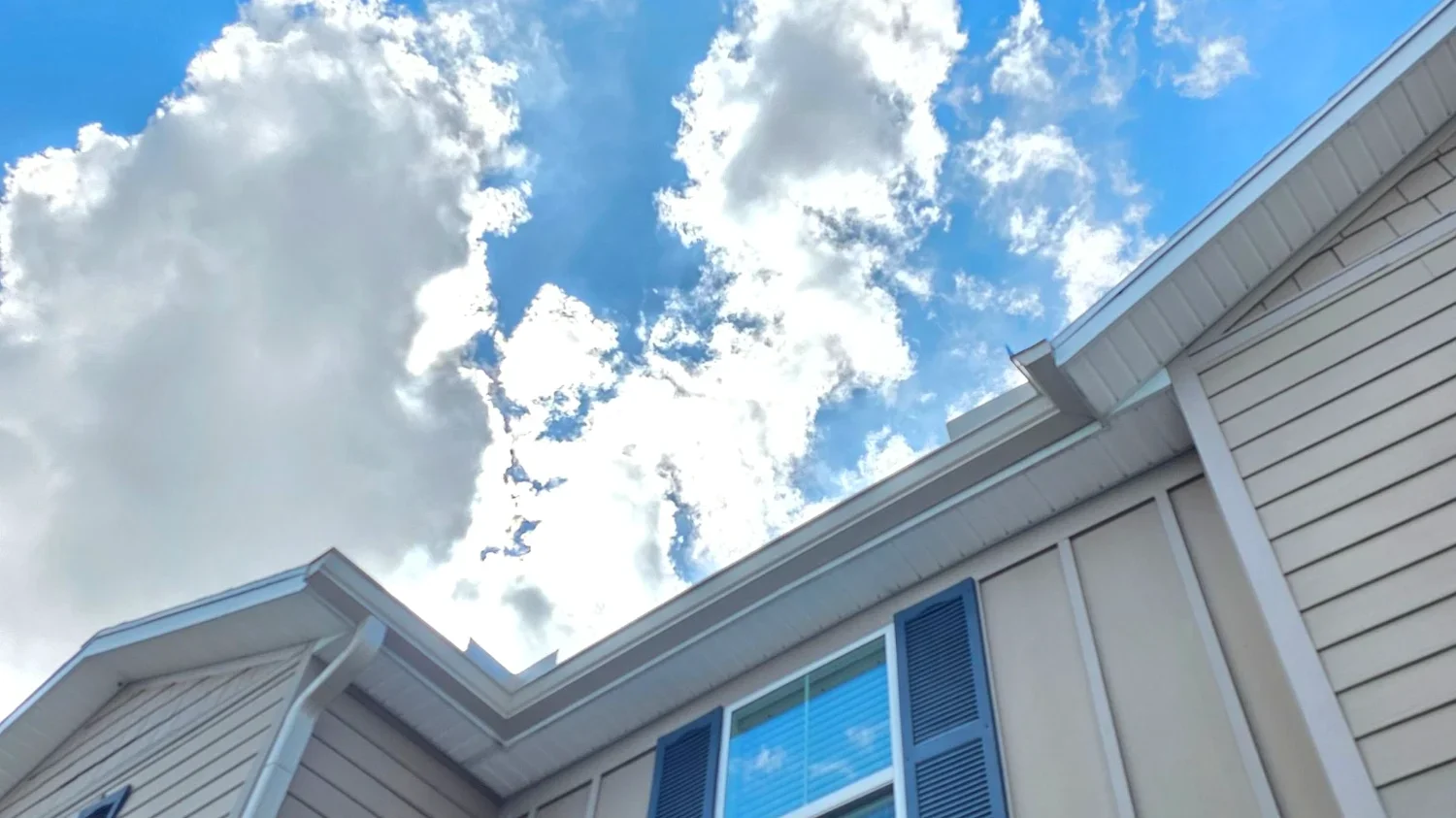 Second-story gutter installation on a large suburban home