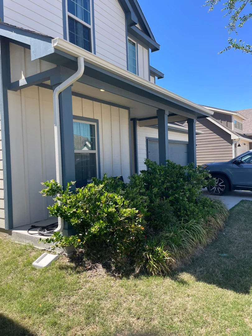 White gutters and downspout on a Plano front porch