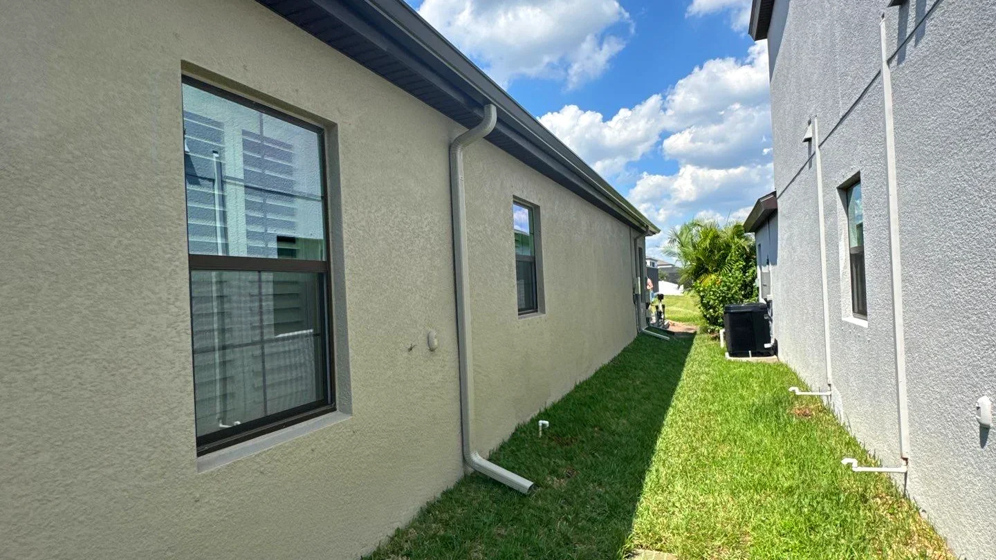 Gutter and downspout drainage along a residential side yard